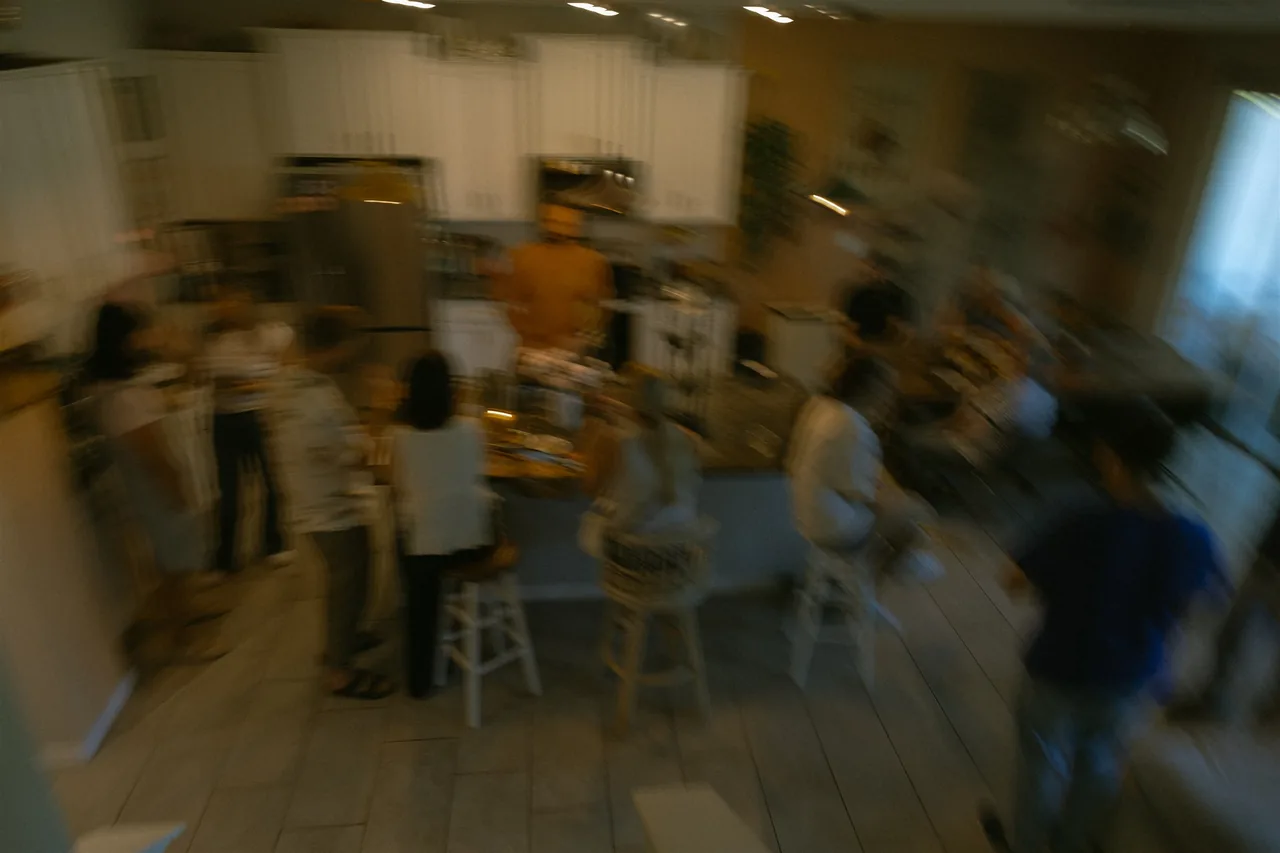 A softly focused gathering of people sharing time together